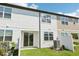 Backyard with sliding glass door and a white fence with grass at 7678 Deer Valley Circle, Tampa, FL 33635