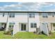 Backyard with sliding glass door and a white fence with grass at 7678 Deer Valley Circle, Tampa, FL 33635