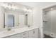A modern bathroom featuring double sinks, ample counter space, and a glass-enclosed shower at 7678 Deer Valley Circle, Tampa, FL 33635
