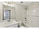 A well-lit bathroom featuring a tub with shower, a sleek vanity, and modern fixtures at 7678 Deer Valley Circle, Tampa, FL 33635