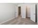 A carpeted bedroom featuring an open closet with modern, neutral paint throughout at 7678 Deer Valley Circle, Tampa, FL 33635