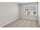 A sunlit bedroom with soft carpet and a large window offering views of the neighborhood at 7678 Deer Valley Circle, Tampa, FL 33635