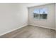 This bedroom features wood-look floors, large window, and neutral paint at 7678 Deer Valley Circle, Tampa, FL 33635