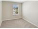 A light and airy bedroom with a large window and neutral carpet at 7678 Deer Valley Circle, Tampa, FL 33635