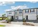 Modern townhomes present varied exteriors with driveways, walkways, and green landscaping at 7678 Deer Valley Circle, Tampa, FL 33635