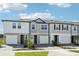 Modern townhomes present varied exteriors with driveways and manicured landscaping at 7678 Deer Valley Circle, Tampa, FL 33635