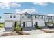 Modern townhomes present varied exteriors with driveways and walkways at 7678 Deer Valley Circle, Tampa, FL 33635
