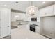 A bright white kitchen with a large island and modern stainless steel appliances at 7678 Deer Valley Circle, Tampa, FL 33635