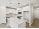 Bright white kitchen featuring a large island, modern appliances, and pendant lighting at 7678 Deer Valley Circle, Tampa, FL 33635