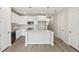 Bright white kitchen with island, stainless steel appliances, and tile backsplash at 7678 Deer Valley Circle, Tampa, FL 33635