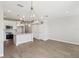 Open concept kitchen and living space with modern lighting and tile flooring at 7678 Deer Valley Circle, Tampa, FL 33635