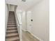Carpeted stairway with white railing, leading to a light and airy living space at 7678 Deer Valley Circle, Tampa, FL 33635