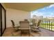Enjoy outdoor dining on this tiled balcony with seating, overlooking serene lake views at 7893 Sailboat Key S Blvd # 304, South Pasadena, FL 33707