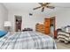 Bedroom with a ceiling fan and storage, alongside laundry access for added convenience at 7893 Sailboat Key S Blvd # 304, South Pasadena, FL 33707