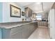 The kitchen boasts granite counters, stainless steel appliances, light-grey cabinetry, and ample storage at 7893 Sailboat Key S Blvd # 304, South Pasadena, FL 33707
