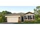 Charming single-Gathering home featuring stone accents, a two-car garage, and a well-manicured lawn at 8023 Sail Clover Ln, Zephyrhills, FL 33540