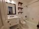 Bathroom featuring a black framed vanity mirror, open shelving, and white tile flooring at 820 Crenshaw Lake Rd, Lutz, FL 33548