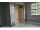 An open bedroom space with neutral walls, an open closet, a bright window, and vinyl floors at 820 Crenshaw Lake Rd, Lutz, FL 33548