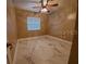 Well-lit bedroom showcasing decorative ceiling fan, hard floors and ample natural light at 820 Crenshaw Lake Rd, Lutz, FL 33548