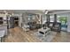 This bright living room showcases hardwood floors, modern furniture, and an open doorway to an outdoor patio at 820 Crenshaw Lake Rd, Lutz, FL 33548