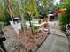 This backyard features a pool, patio umbrellas, palm trees and garden plants at 820 Crenshaw Lake Rd, Lutz, FL 33548
