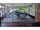 Screened-in porch featuring neutral flooring, outdoor seating, and ample lighting at 820 Crenshaw Lake Rd, Lutz, FL 33548