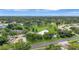 Expansive aerial view highlighting the homes, golf course, tranquil ponds, and verdant trees at 900 Maclaren N Dr # D, Palm Harbor, FL 34684