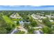 Wide angle aerial view of community featuring homes, golf course, ponds, and lush trees at 900 Maclaren N Dr # D, Palm Harbor, FL 34684