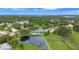 Stunning aerial view showcasing a property with pond access, a golf course, and lush green trees at 900 Maclaren N Dr # D, Palm Harbor, FL 34684