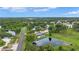 Drone shot featuring the community, pond, green spaces, and surrounding neighborhood at 900 Maclaren N Dr # D, Palm Harbor, FL 34684