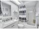 Bright bathroom features a shower and tub combo with a modern vanity and sink at 900 Maclaren N Dr # D, Palm Harbor, FL 34684