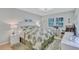 Bright bedroom features leafy comforter set, rocking chair, and a desk with natural light at 900 Maclaren N Dr # D, Palm Harbor, FL 34684