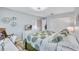 Spacious bedroom features leafy comforter set, closet, and view into hallway at 900 Maclaren N Dr # D, Palm Harbor, FL 34684