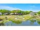 Landscaped community entrance featuring the 'Highland Lakes' sign and lush greenery at 900 Maclaren N Dr # D, Palm Harbor, FL 34684