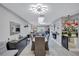 Open dining and living space boasting light gray flooring and a modern ceiling fixture at 900 Maclaren N Dr # D, Palm Harbor, FL 34684