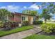Charming single-story home with a well-maintained yard, brick accent, and inviting entrance at 900 Maclaren N Dr # D, Palm Harbor, FL 34684