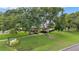 Lovely villa with manicured lawns, mature trees, and community signage at 900 Maclaren N Dr # D, Palm Harbor, FL 34684