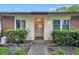 Inviting front entrance with manicured bushes and walkway, brick facade on the side at 900 Maclaren N Dr # D, Palm Harbor, FL 34684