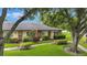 Well-kept villa with vibrant landscaping, a walkway, and a lush green lawn at 900 Maclaren N Dr # D, Palm Harbor, FL 34684
