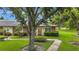Inviting villa featuring well-manicured lawn and mature trees, offering a tranquil setting at 900 Maclaren N Dr # D, Palm Harbor, FL 34684