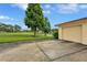 Attached garage with a driveway, situated near the golf course and water view at 900 Maclaren N Dr # D, Palm Harbor, FL 34684