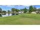 Beautiful golf course home showcasing serene waterfront views and lush greenery at 900 Maclaren N Dr # D, Palm Harbor, FL 34684