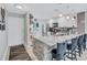 Stylish kitchen featuring a marble counter with bar seating, stainless steel appliances, and modern pendant lights at 900 Maclaren N Dr # D, Palm Harbor, FL 34684