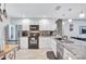 Bright kitchen featuring stainless steel appliances, stylish countertops, and white cabinets at 900 Maclaren N Dr # D, Palm Harbor, FL 34684