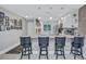 Stylish kitchen featuring a marble counter with bar seating, stainless steel appliances, and modern pendant lights at 900 Maclaren N Dr # D, Palm Harbor, FL 34684