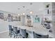 Open kitchen features a marble counter with bar seating, stainless steel appliances, and modern pendant lights at 900 Maclaren N Dr # D, Palm Harbor, FL 34684