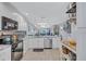Bright open kitchen featuring stainless steel appliances, stylish countertops, and a view to the living room at 900 Maclaren N Dr # D, Palm Harbor, FL 34684