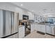 Bright kitchen featuring stainless steel appliances, stylish countertops, and white cabinets at 900 Maclaren N Dr # D, Palm Harbor, FL 34684