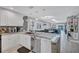 Open kitchen features a stainless steel dishwasher, stylish countertops, and a view to the living room at 900 Maclaren N Dr # D, Palm Harbor, FL 34684