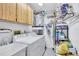Functional laundry room with washer, dryer, sink, storage cabinets, and water heater for added convenience at 900 Maclaren N Dr # D, Palm Harbor, FL 34684
